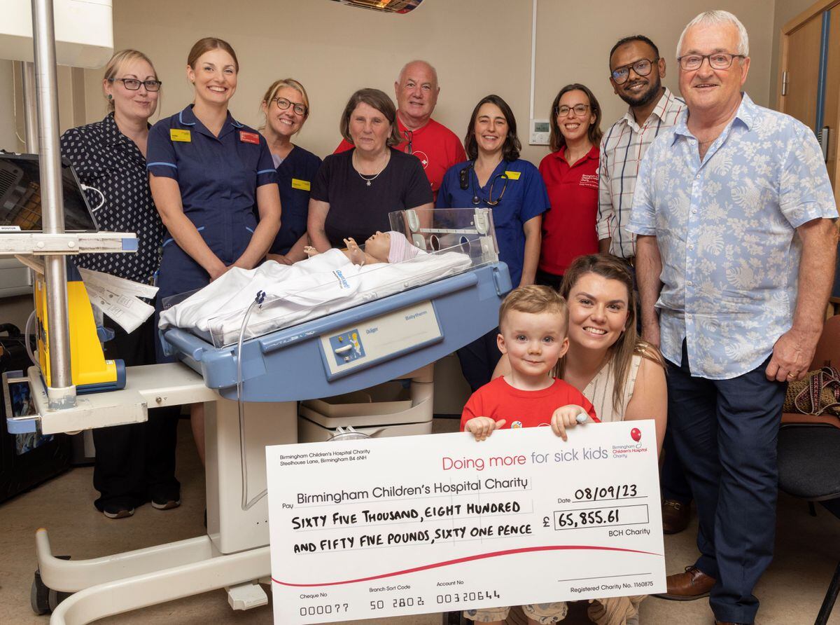 Teddy Phillips presents the cheque to staff at the hospital