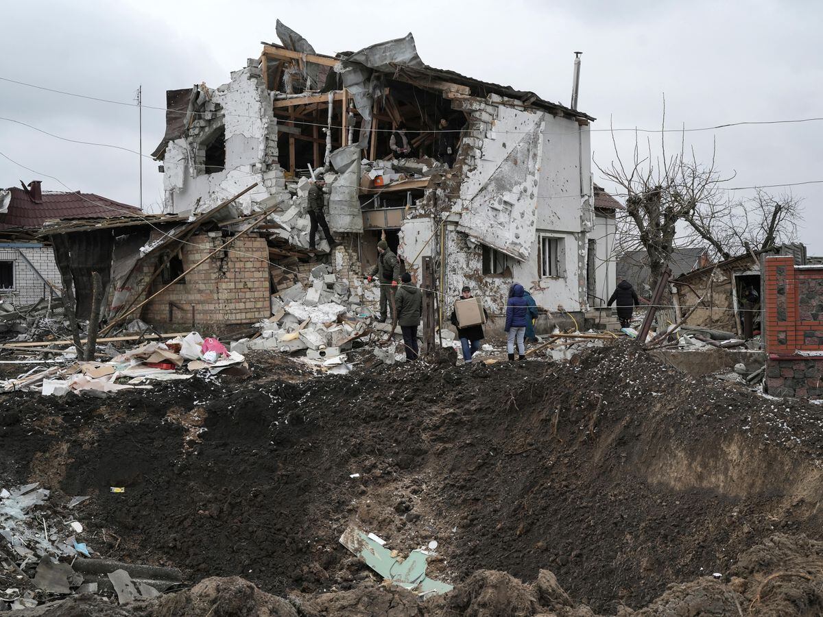 A crater from an explosion is seen next to a destroyed house after a Russian rocket attack in Hlevakha, Kyiv region, Ukraine
