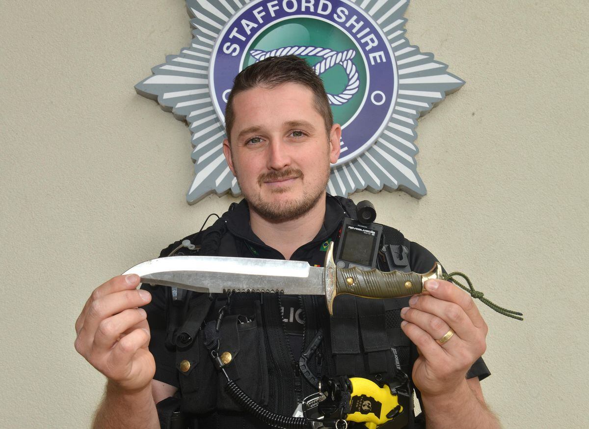 PC Paul Hamilton pictured with one of the fearsome knives handed in at last year's knife Amnesty at Staffordshire Police Headquarters in Weston Road, Stafford.    