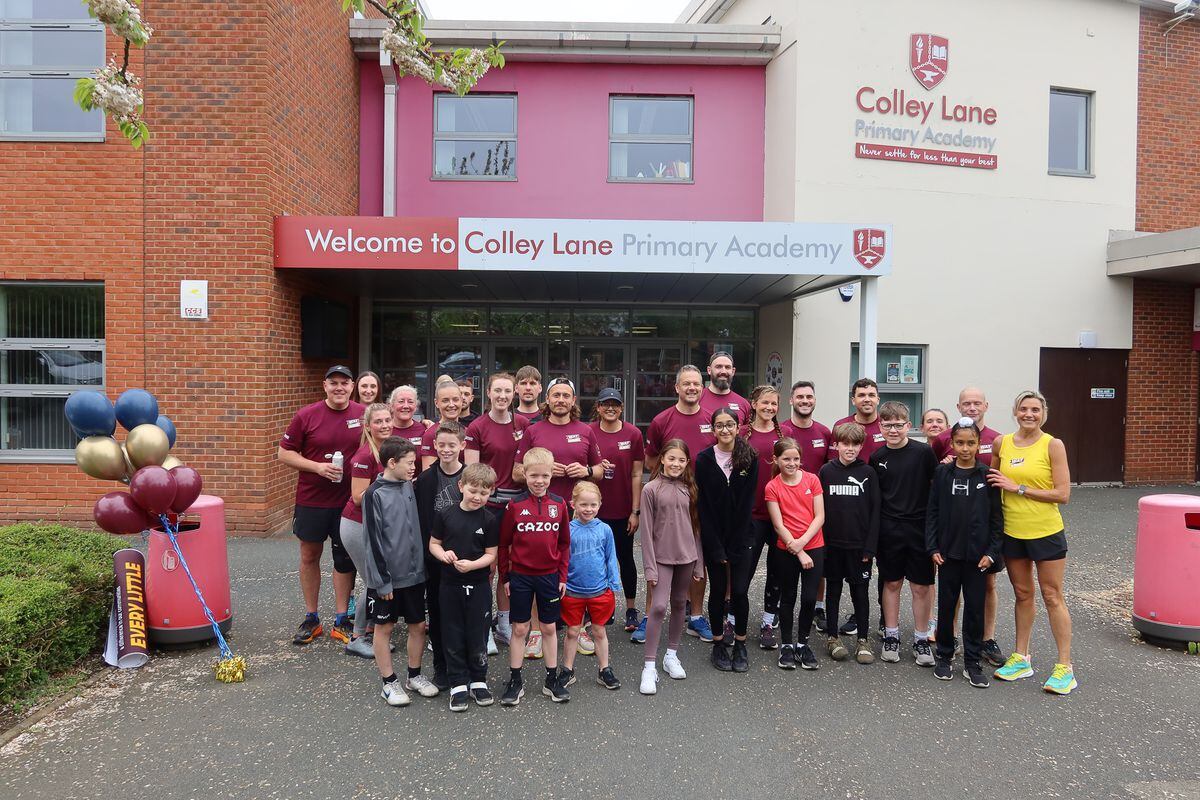 Teachers and pupils greet the runners at Colley Lane Primary Academy in Halesowen