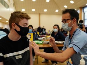 Owen Morrison, 15, receives a Covid-19 vaccine from student nurse Anthony McLaughlin at the Glasgow Central Mosque (Jane Barlow/PA)