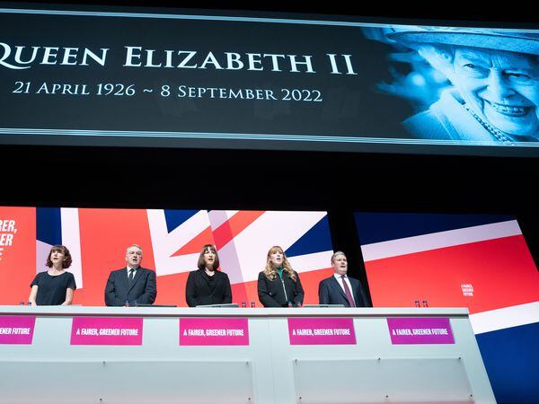 Labour party leader Sir Keir Starmer (right) leads tributes to the Queen as the national anthem is sung during the Labour Party conference in Liverpool (Stefan Rousseau/PA)