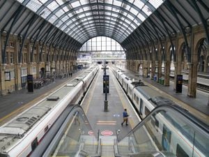 Empty platform and stationary trains at Kings Cross station in London