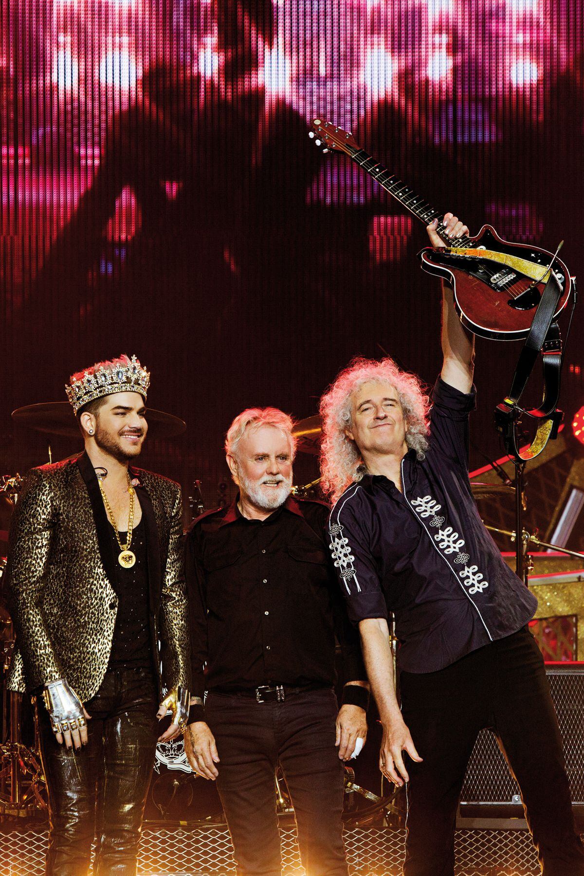 Adam Lambert, Roger Taylor and Brian May take in the applause of the crowd after the show
