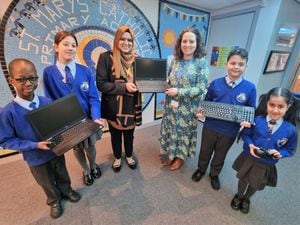 Councillor Obaida Ahmed donating devices from Wolves Tech Aid to headteacher Vicky Minihane and pupils from St Mary’s Catholic Primary Academy