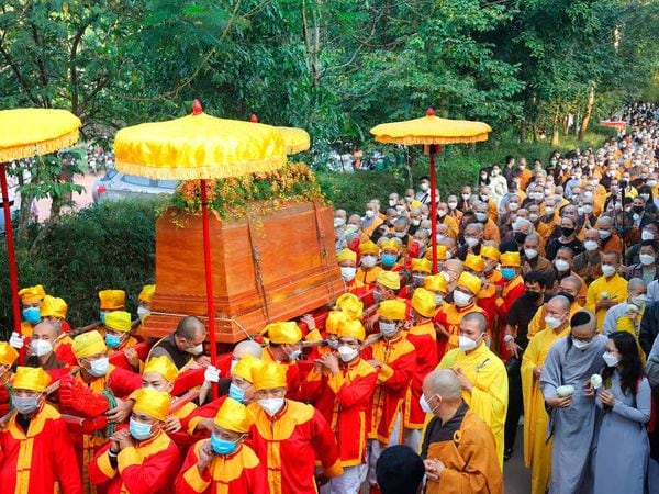 Coffin of Vietnamese Buddhist monk Thich Nhat Hanh is carried to the street during his funeral in Hue, Vietnam Saturday, Jan. 29, 2022. A funeral was held Saturday for Thich Nhat Hanh, a week after the renowned Zen master died at the age of 95 in Hue in central Vietnam. (AP Photo/Thanh Vo)
