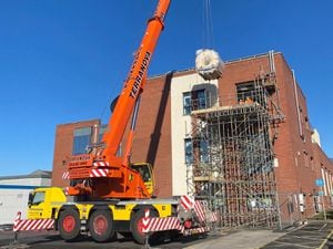 The old scanner being lifted out of the radiology building