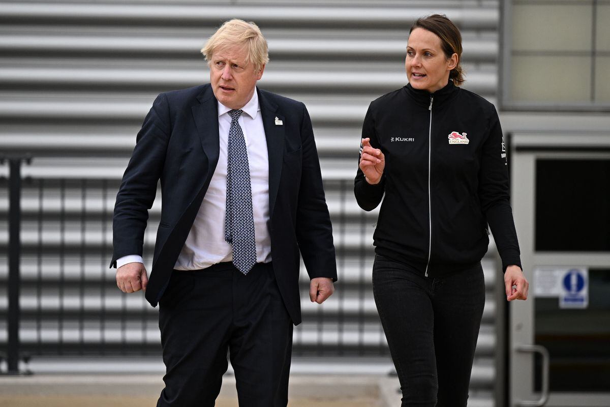 Boris Johnson speaks with Team England track and field team leader Kelly Sotherton during a visit to Alexander Stadium in Birmingham.