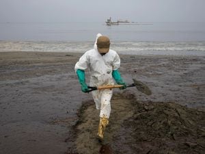 Peru oil spill clean-up worker