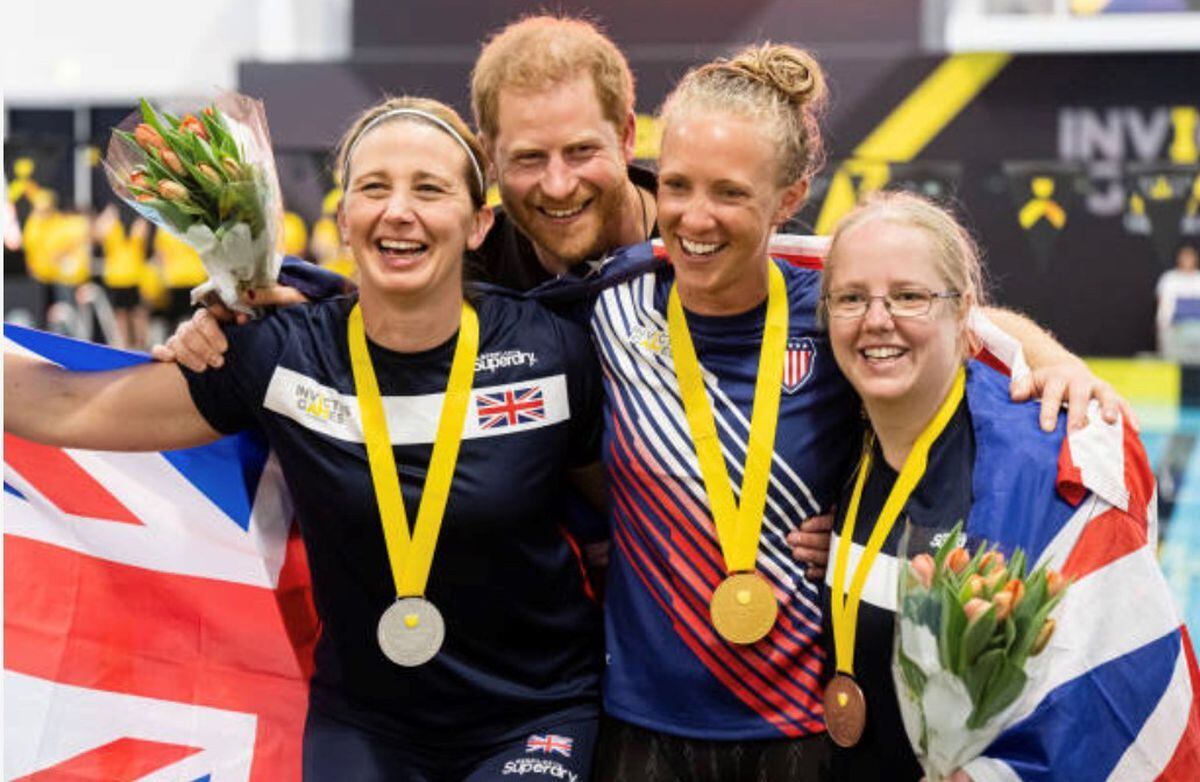 Kelly celebrating one of her silver medal successes with Team UK colleagues and Prince Harry.