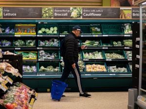 File photo of a shopper walking through the salad aisle in a supermarket