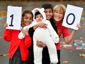 Rhiyun and Rhea Chauhan walked 10 miles to help raise funds for a new defibrillator for St John Bosco Primary School in West Bromwich. They are pictured with their brother Jovan Chauhan and Deborah Whitehouse from the school.
