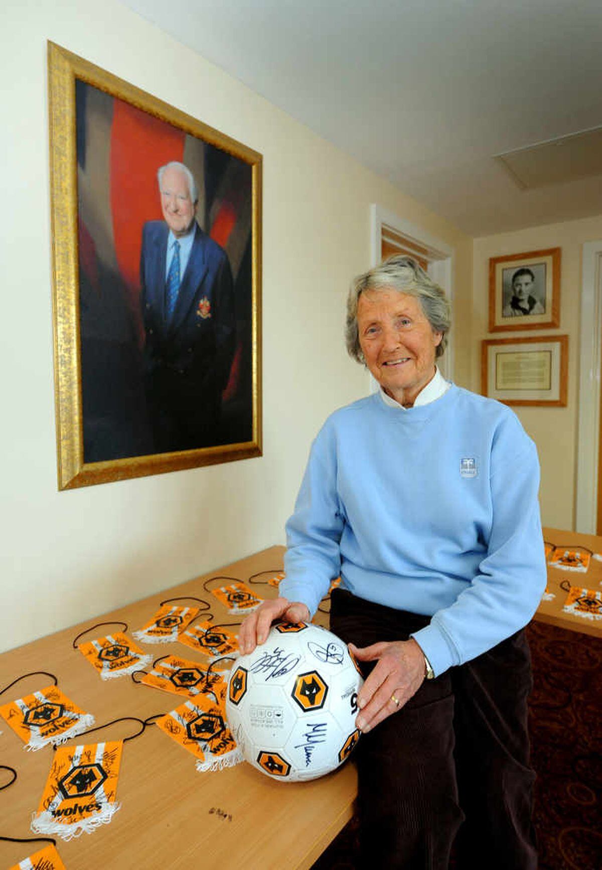 Rachael Heyhoe-Flint next to a portrait of her friend Sir Jack Hayward, at the Wolves training ground.