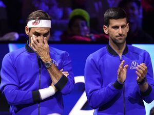 Novak Djokovic, right, applauds alongside an emotional Roger Federer