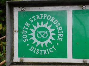 The South Staffordshire District logo on a street sign