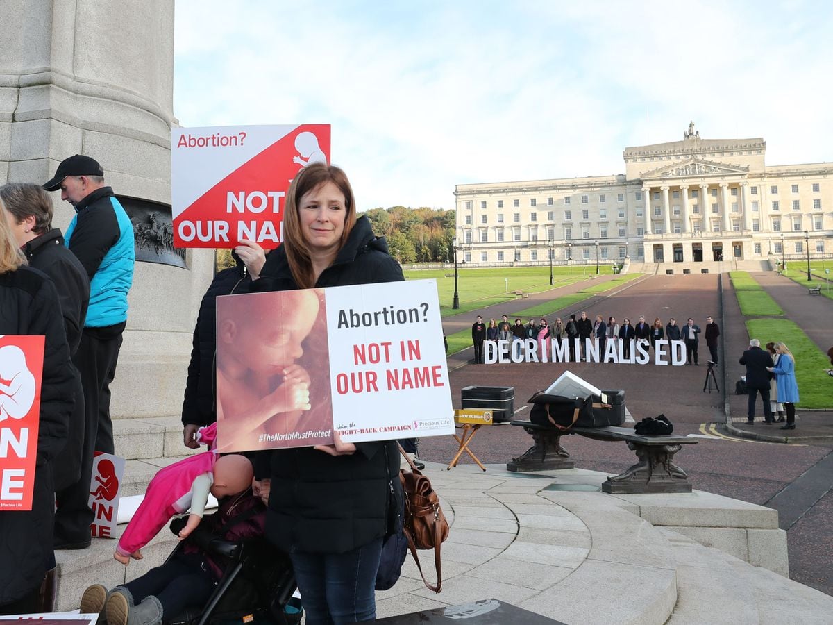 Pro-life and pro-choice activists in the grounds of Stormont Parliament