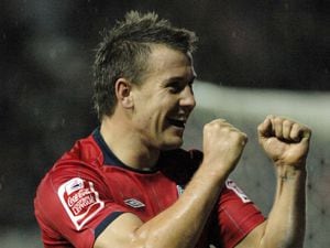 Simon Cox celebrates his goal during his time at West Brom