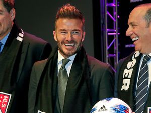 David Beckham, left, talks with Major League Soccer Commissioner Don Garber