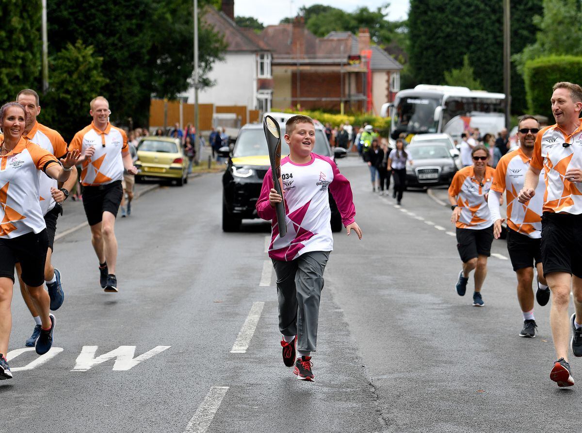 Marcus Galli jogs along the course with members of West Midlands Police