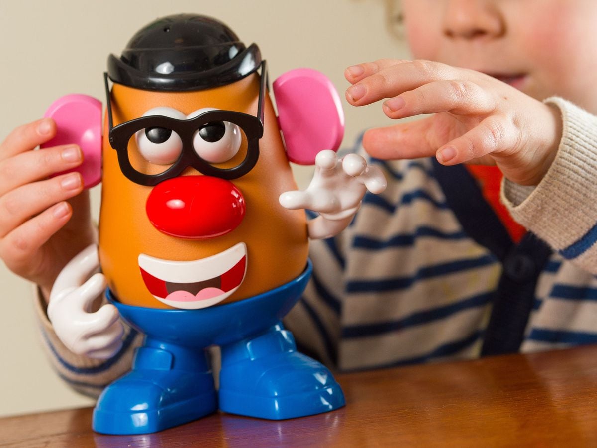 A child plays with a Mr Potato Head