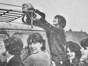Girls clamber on the group's van in Cannock during their 1964 gigs in the town.