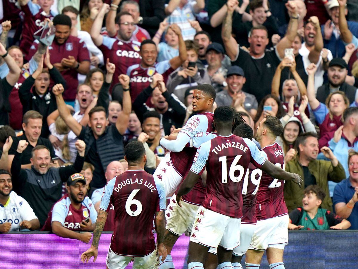 Aston Villa players celebrate in front of the fans 