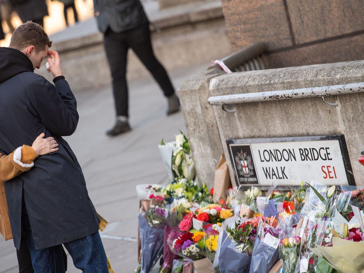 People lay flowers at London Bridge for the victims of the London Bridge terrorist attack