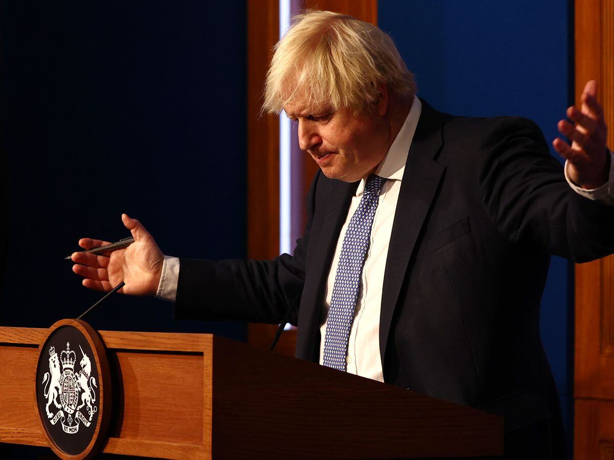 Prime Minister Boris Johnson gestures whilst speaking at a press conference.