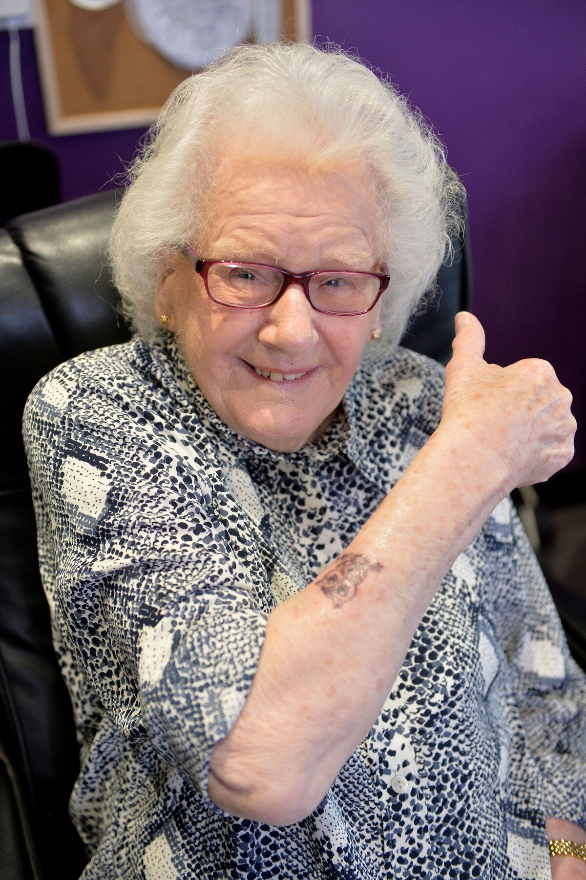 Joan celebrating her new tattoo on her 90th birthday.