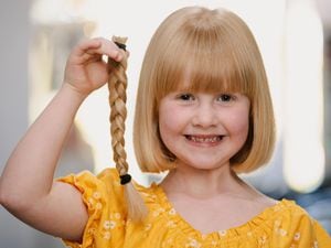Polly Davis, six, has raised more than £500 for The Little Princess Trust after having eight inches chopped off her hair