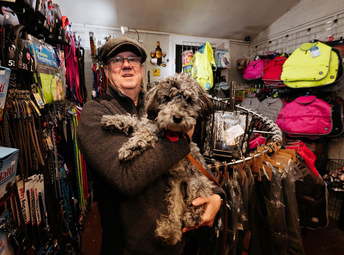 Shop owner Charlie Butler with Rupert, a local customer.