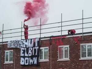 Protestors on the roof at UAV Engines Ltd in Shenstone. Picture by Guy Smallman