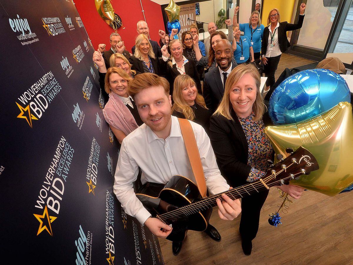 Perton musician Ryan Evans was on hand to get the party started with BID MD Cherry Shine and at the back: Alison Westwood (Thornes Solicitors), Mel Bryett (railway station manager), Sioux Jones from Rudell's Jewellers , Carole Taylor (Access to Business), Mark Bourton-Payne (Nationwide) and other city business figures