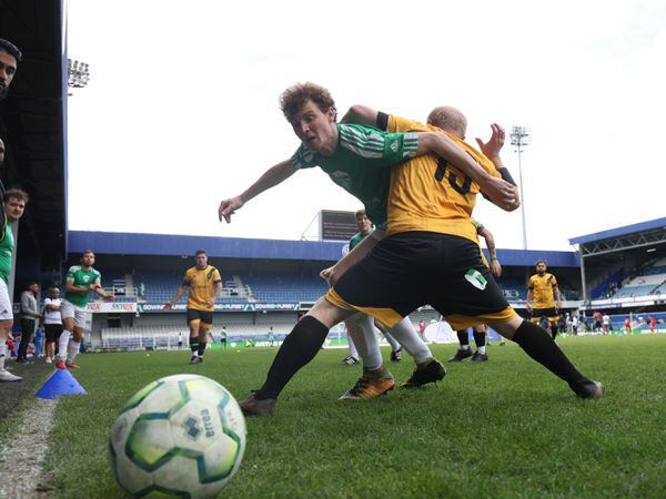 AFC South London player Theo Cox (left), tackles during a match against Westbourne United at the Grenfell Memorial Cup