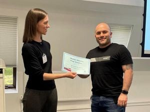  Chris Scordis being presented with his £50 voucher from Helen Alexander, Co-Chair of the Association of Chartered Physiotherapists in Cardiovascular Rehabilitation (ACPICR).