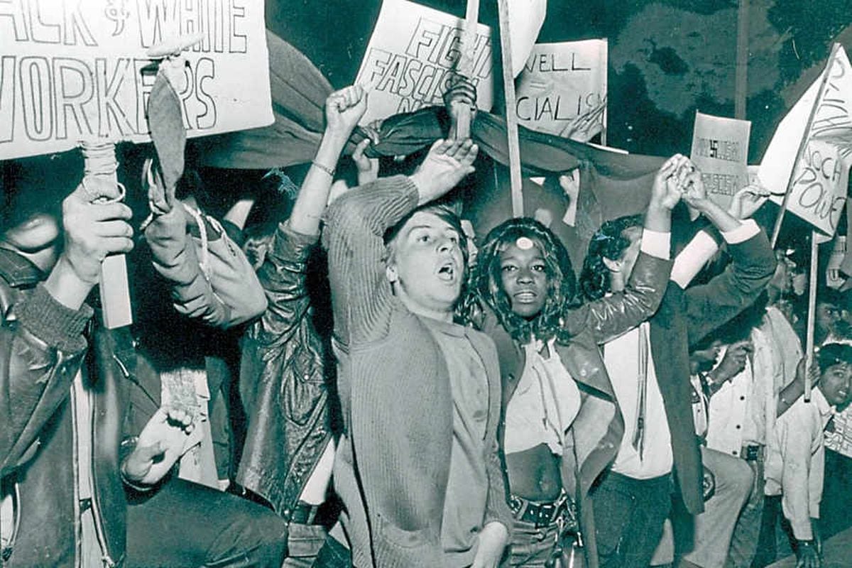 Angry protesters take to the streets with placards in opposition to Powell's words during the late 1960s