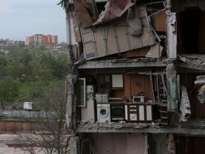 A part of an apartment is seen at the side of damaged during a heavy fighting buildings in Mariupol, in territory under the government of the Donetsk PeopleÃ¢ÂÂs Republic, eastern Ukraine, Thursday, May 13, 2022. (AP Photo)