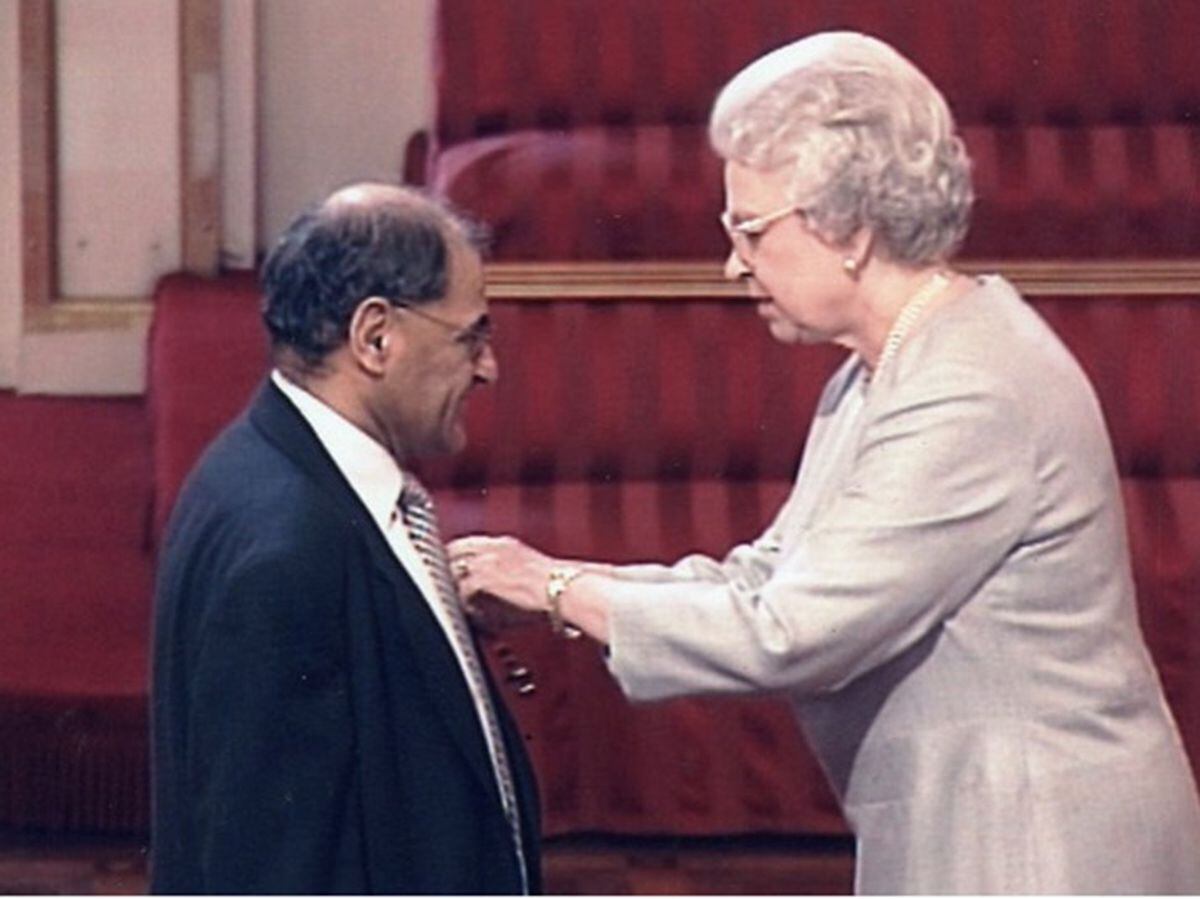 Professor Abdul Gatrad receiving his OBE from the Queen in 2002
