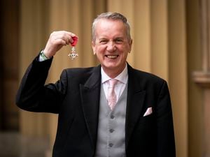 Frank Skinner shows off his medal after after being made a member of the Order of the British Empire (MBE) 