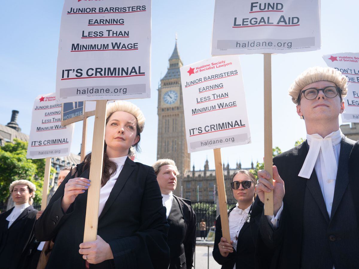 Criminal defence barristers outside the Houses of Parliament in London last