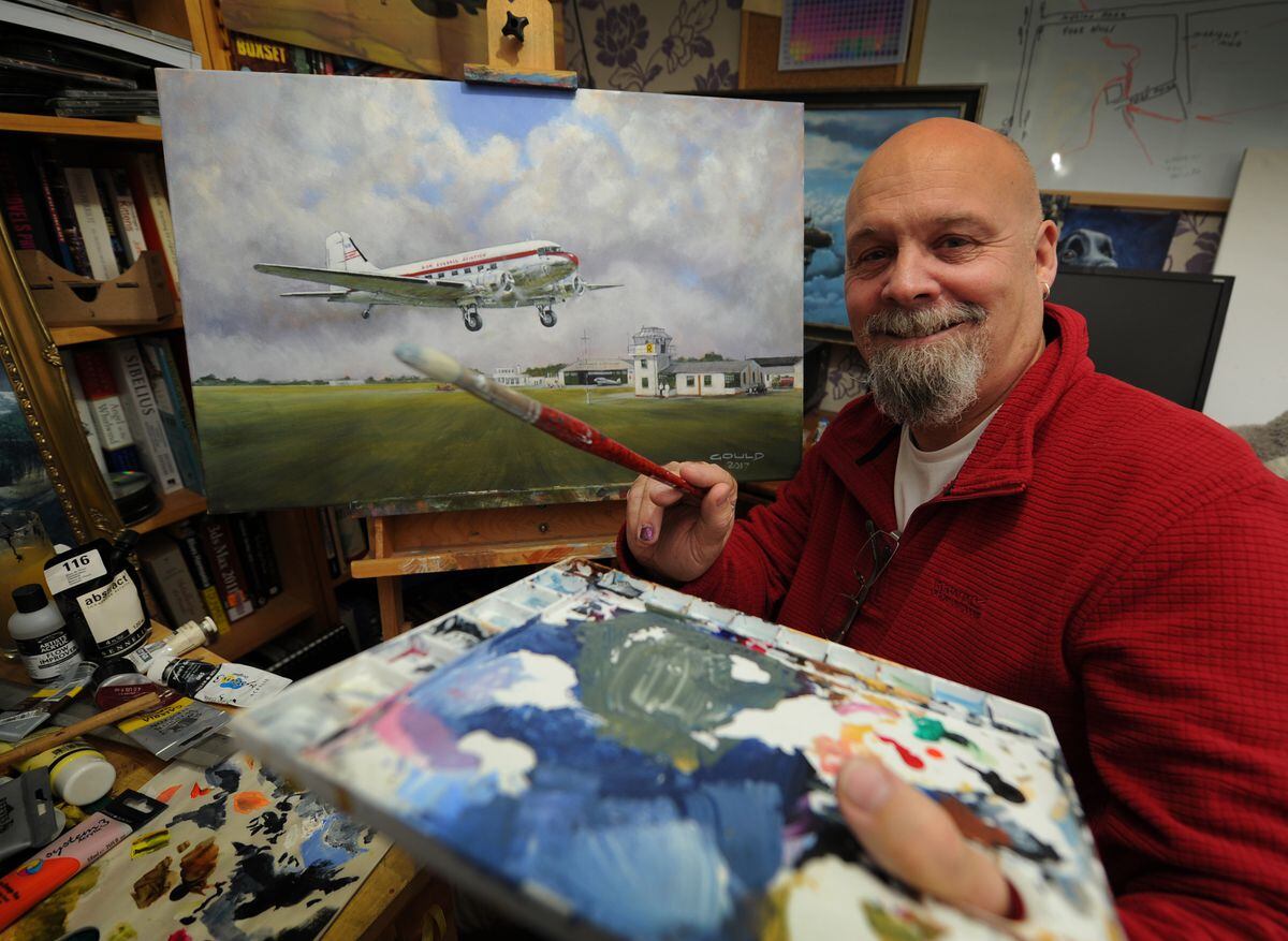 Artist Andy Gould, of Wolverhampton, with his painting of Pendeford Airport in 1958, featuring a Don Everall DC-3.