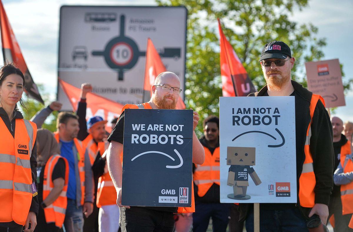Placards at the protest had slogans about not being robots