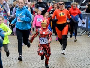 The fun runners - including a mini Iron Man - set off