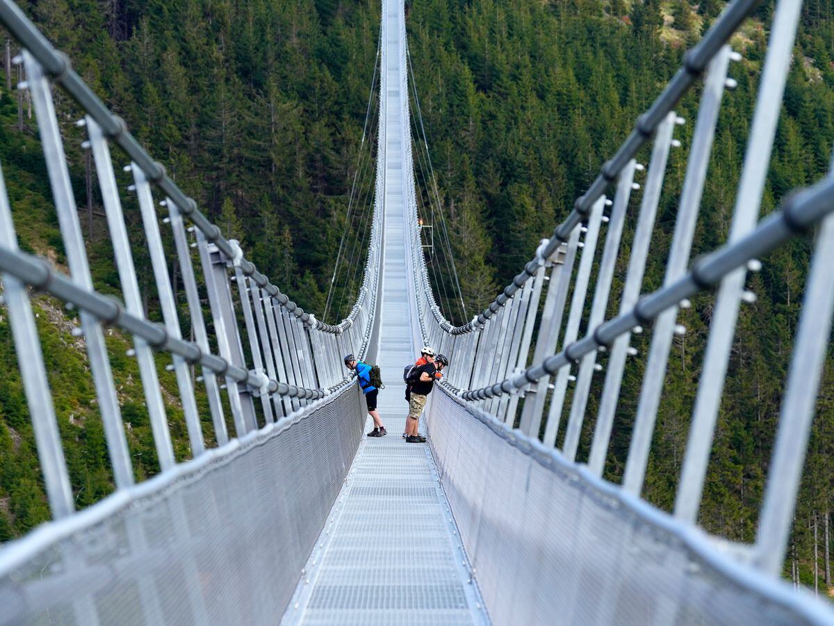 People stand on the suspension bridge a day before its official opening at a mountain resort in Dolni Morava, Czech Republic