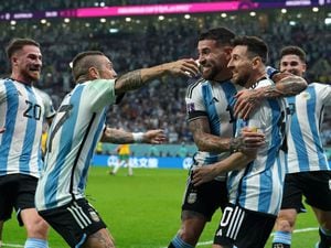 Lionel Messi, second right, is mobbed by his team-mates after scoring Argentina's opening goal against Australia