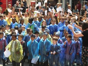Pupils take part in a Singing in the Rain performance at Queen Square in 2018.