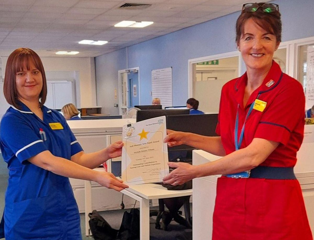 Michelle Bonney-Wheate (left) being presented with her Nell Phoenix Award certificate by Cath Wilson, deputy director of nursing at the trust