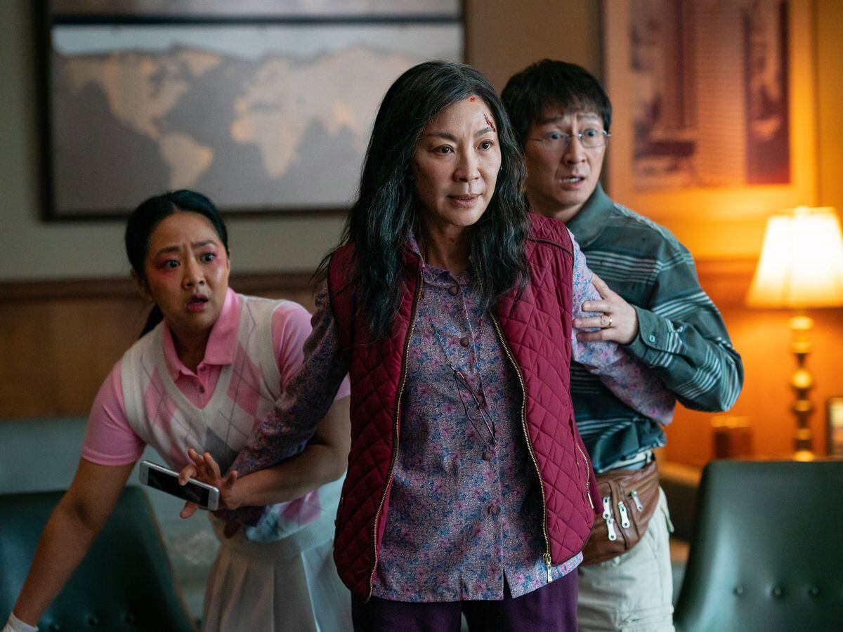 Stephanie Hsu as Joy Wang, Michelle Yeoh as Evelyn Quan Wang and Ke Huy Quan as Waymond Wang in Everything Everywhere All At Once