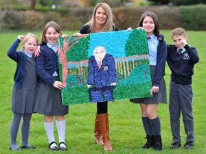 Teacher Charlotte Priest with some of the children at Palmers Cross Primary School who created a large picture of Sir Tom Moore