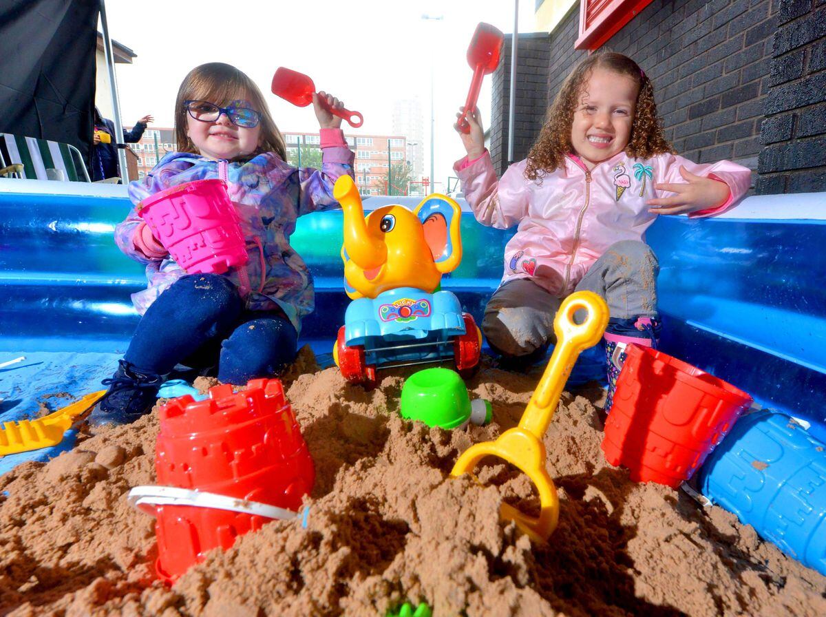 Bonnie Hunt and Skyla Lewis have fun on the makeshift beach at Hope Community Project
